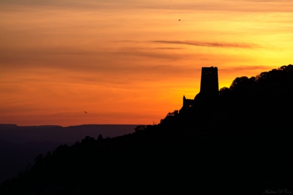 The Desert View Watchtower at sunrise; you can see a few people silhouetted at the lookout point. desert view sunrise grand canyon national park