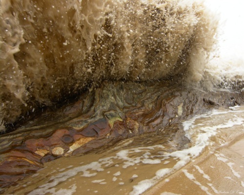 A wave breaks on the rocks; this photographer got wet... :D crystal cove beach wave