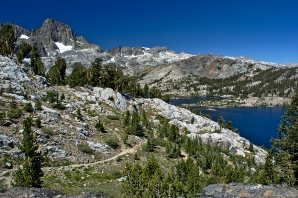 The John Muir Trail winds its way down toward Garnet Lake; Banner Peak rises above the lake to the west. sierra nevada mountains ansel adams wilderness john muir trail