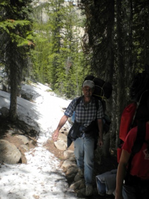 Dad and Jason keep their feet dry and skirt the snow drifts sawtooth mountains wilderness snow backpacking