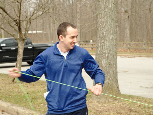 Grant retrieves the bear bag line green paracord