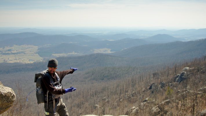 Yours truly shows off the view, tour-guide style. landscape vista old rag shenandoah national park