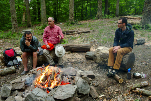 We gather around the fire for stories and relaxation. campfire cooking dinner
