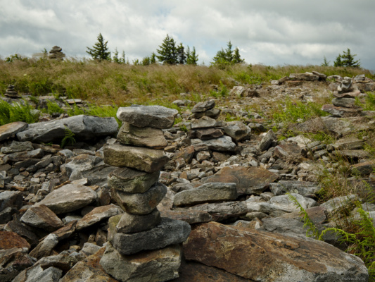 At the top of the rocky hill is a small city of cairn skyscrapers dolly sods wilderness cairn