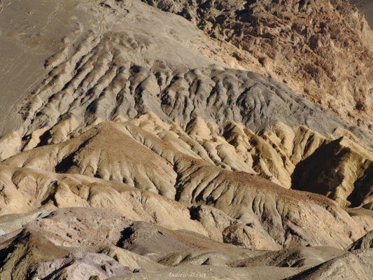 The hills here change quickly from a gray-brown to light tan. death valley artists palette