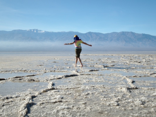 Aileen ventures out into the shallow pool in Badwater Basin, barefoot. death valley badwater basin