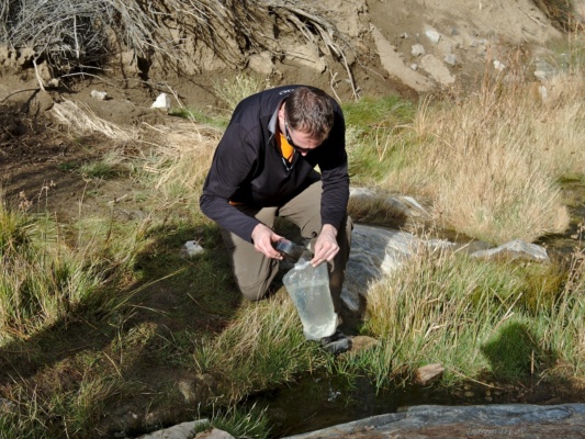 Brian fills a water bladder from the small gurgling stream. death valley deadhorse canyon spring