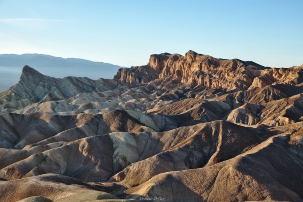 The evening light streams across striped hills at Zabriskie Point; it's easy to see why this is one of the most popular viewpoints in the park! death valley zabriskie point
