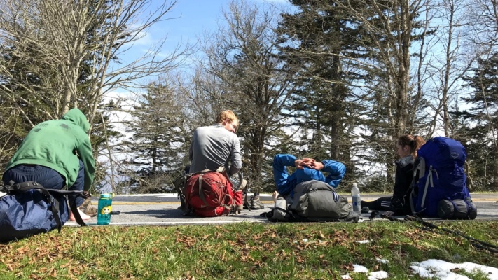 While the trail, trees, and rocks are covered in soggy snow, the road is dry! Photo Credit: Yi-Chun
