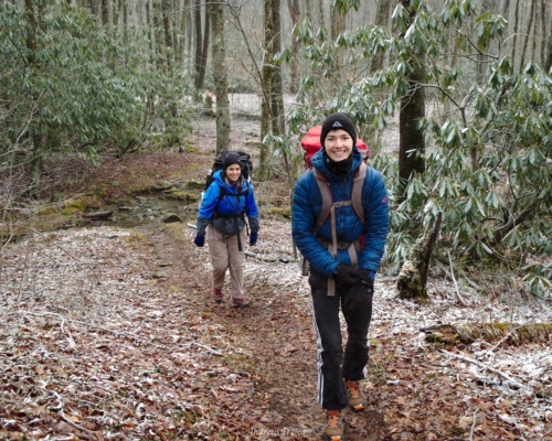 Lulu and Tibor are all smiles despite the falling snow smoky mountains backpacking