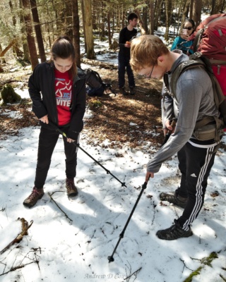 McKenzie and Greg play a game of Tic Tac Toe in the snow during a snack break smoky mountains backpacking