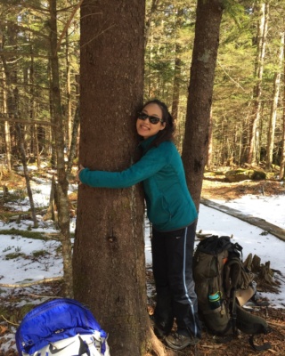 Yi-Chun stretches during a hiking break. Photo Credit: McKenzie