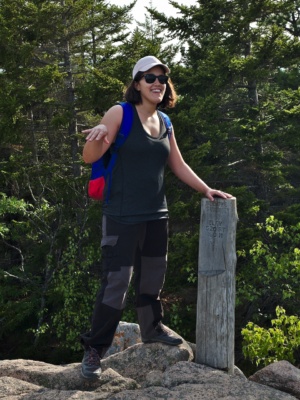Kenza with the Beehive summit sign acadia beehive summit