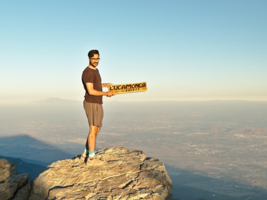 Nihal with one of several Cucamonga summit signs cucamonga summit