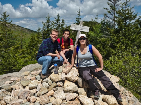 Robert, Juan, and Kenza pose in front of the South Bubble summit sign: elevation: 768' acadia day hiking south bubble summit