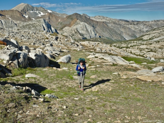 Amanda treks through the alpine country toward Frozen Lake Pass sierra high route lake basin