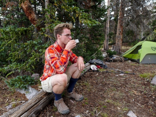 Brian enjoys a hot drink at camp uinta mountains camping