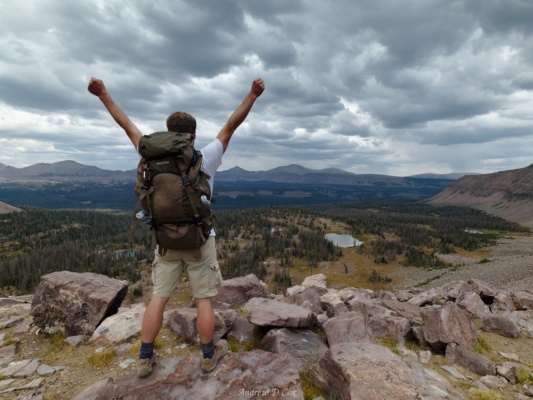 A power pose on top of a high mountain pass uinta mountains rocky sea pass