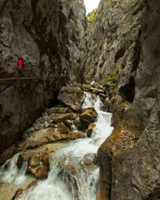 Several fellow hikers make their way along the narrow walkway in Hollental Canyon alps hollental canyon hiking