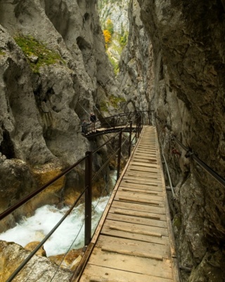 A thin bridge crosses the canyon and descends into yet another tunnel on the other side. alps canyon bridge hollental