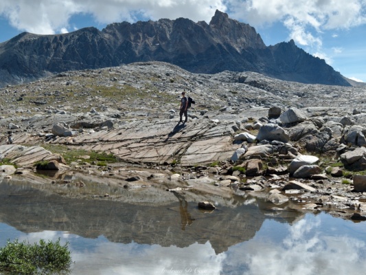 Josh surveys the terrain and Mt Humphreys towers behind him humphreys basin backpacking