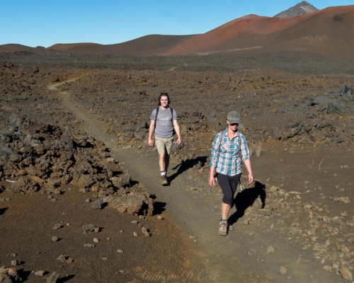 Brian and Diane hiking through a field of gnarly lava rock haleakala lava trail hiking