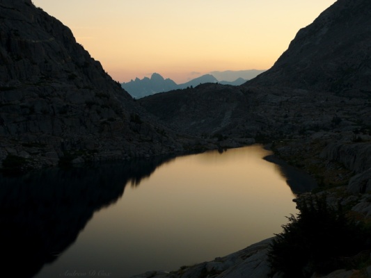 The fading evening light reflects in Lower Palisade Lake sierra high route dusk