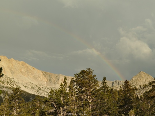 After the storm, a faint rainbow appears above the ridge pine creek trail rainbow