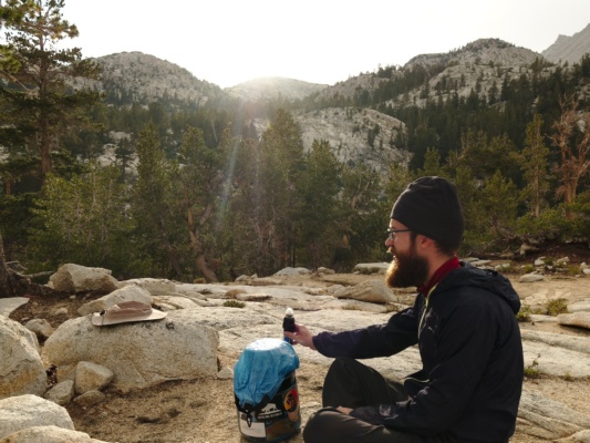 Daniel enjoys the warm sunlight streaming through the clouds honeymoon lake camping