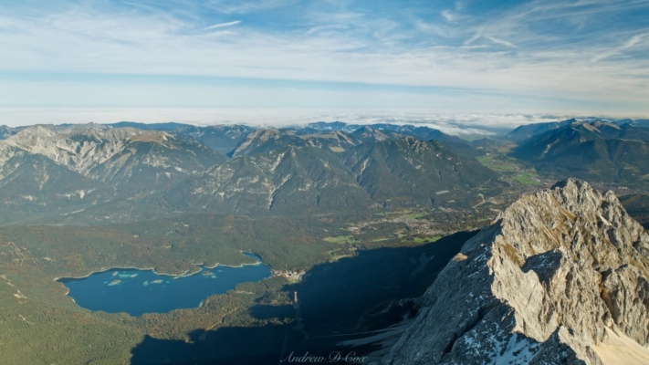 Eibsee Lake and the mountains surrounding Garmisch-Partenkirchen are dwarfed by Zugspitze. In the distance, Bavaria is covered in cloud alps germany