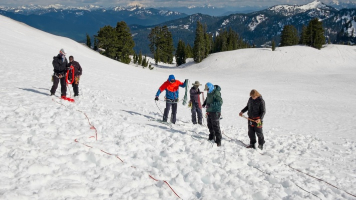 After a full day of snow school, group members coil up the ropes before returning to camp mount baker snow school