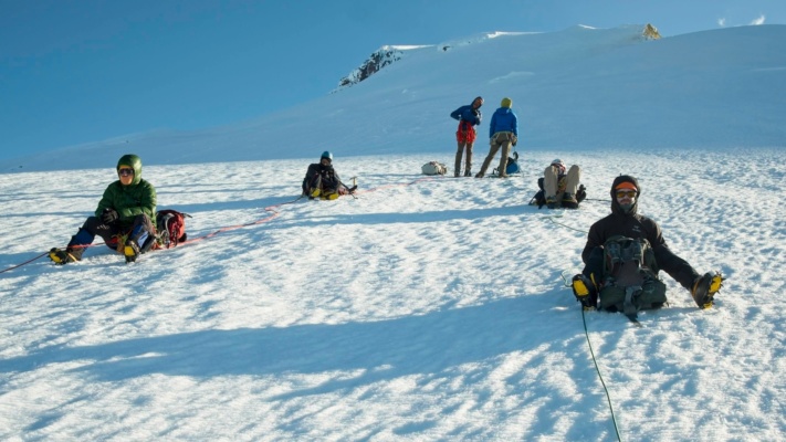The group takes a break during the long summit bid mount baker easton glacier mountaineering