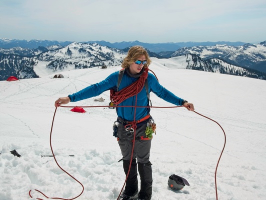 Bear measures the distance between tie-in points on the rope mount baker mountaineering