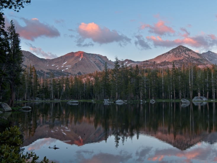 Red Peak and the surrounding mountains are reflected in the calm waters of Lower Merced Pass Lake sierra nevada merced pass lake