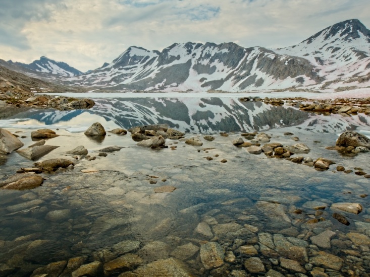 After a winter of heavy snow, Wanda Lake remains covered in snow and ice well into August! sierra nevada john muir trail wanda lake