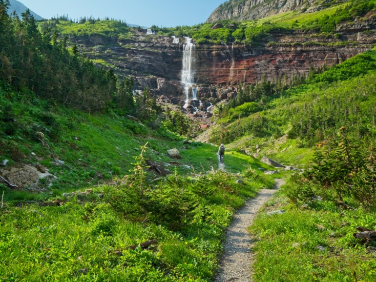 Steve hikes toward the waterfall glacier national park