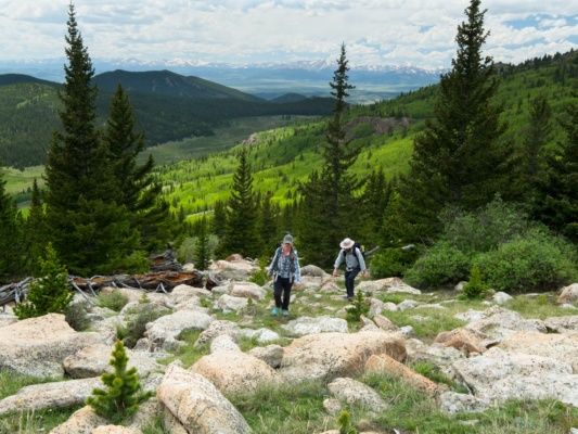 Diane and Daniel work their way up the slope, with excellent views of snow-capped peaks behind them alphabetizer