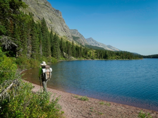 Steve walks down the beach along Elizabeth Lake glacier national park elizabeth lake