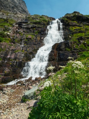 A roaring cascade feeds into Lake Ellen Wilson glacier national park
