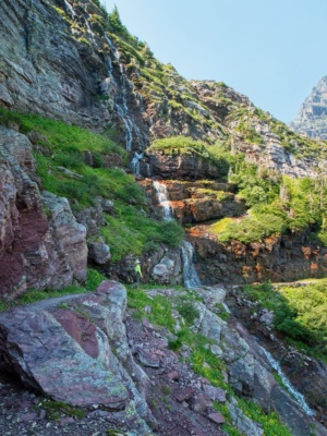 As we climb higher we pass half a dozen cascades and small creeks flowing from glaciers higher up in the mountains glacier national park waterfall cascade