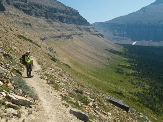 The trail descends gradually, all the while hugging the rocky slope glacier national park trail