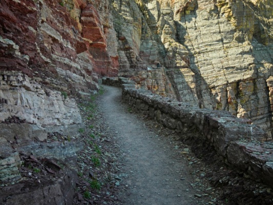 The trail sticks to the cliff face as it approaches the Ptarmigan Tunnel glacier national park