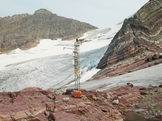 A small research station stands beside the receding Sperry glacier glacier national park sperry glacier