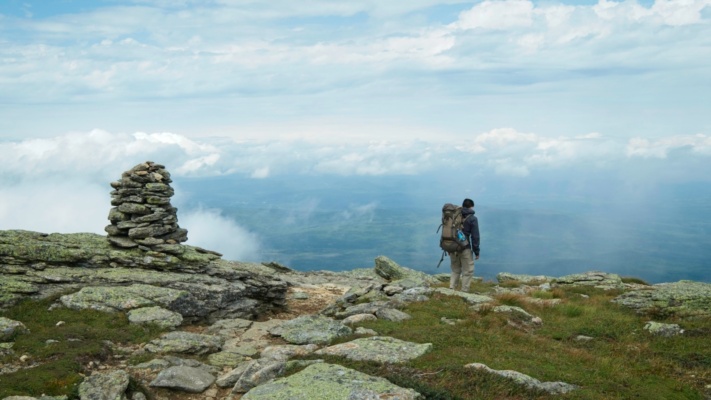 Juan descends from Mount Lafayette with sweeping views of the valley below pemi loop