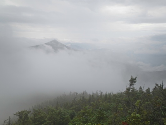 The low-hanging clouds obscure most of the surrounding landscape, but a few peaks poke out here and there pemi loop