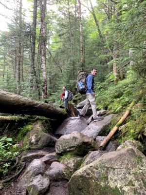 The minute we step out of camp, we begin hopping between slippery rocks... what could go wrong? Photo credit: Diane pemi loop