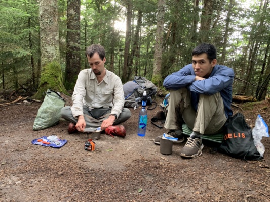 Juan and I wait for our dinners to rehydrate. We're tired and muddy after a long day of hiking. Photo credit: Diane pemi loop