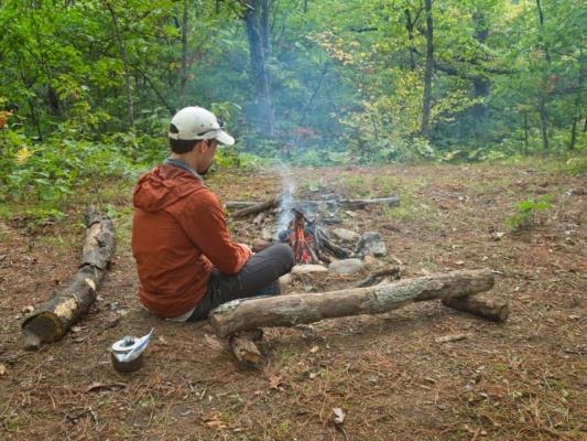 I stare into the fire while waiting for my dinner to rehydrate. Photo credit: Kenza camping