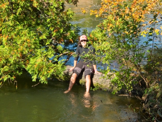 Kenza soaks her feet in the river during a break manistee river trail