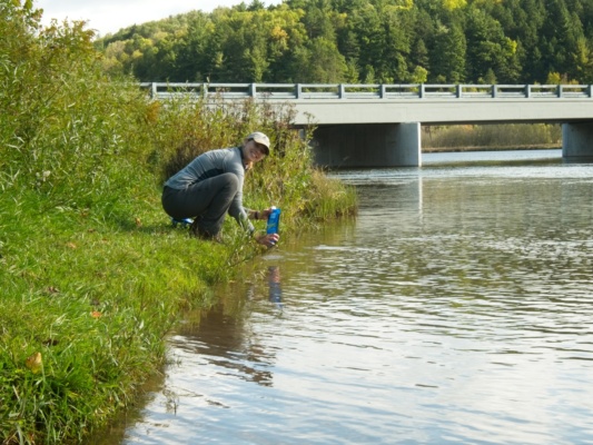 Emily filters water from the Manistee River manistee river